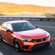 A photo of an orange Honda Civic SI.